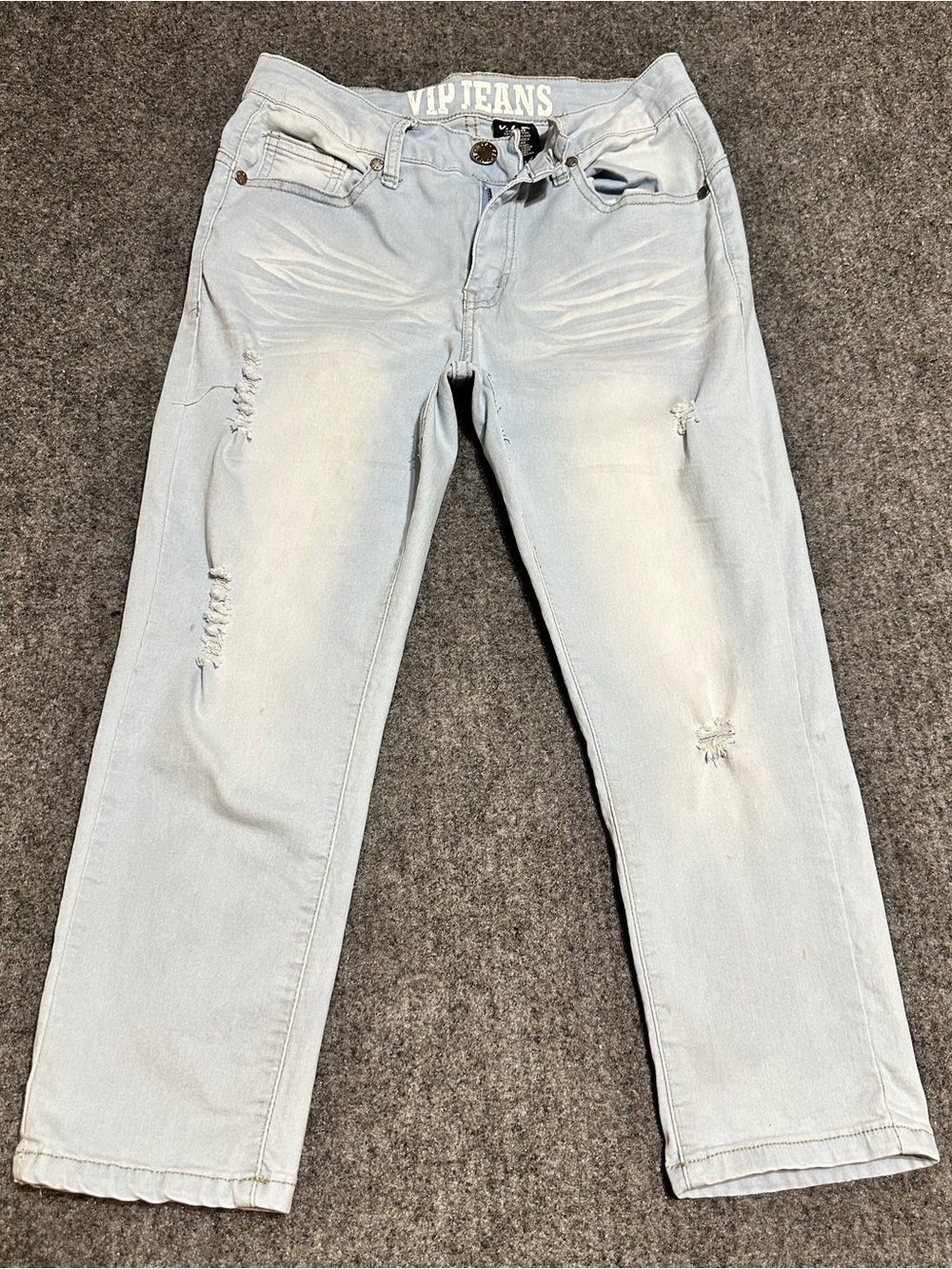 These are light-wash distressed jeans by VIP Jeans featuring whiskering